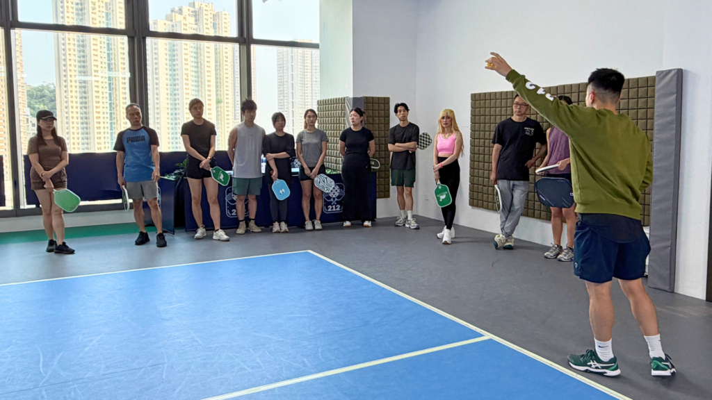 A beginner learning fundamental pickleball tips on a local court.